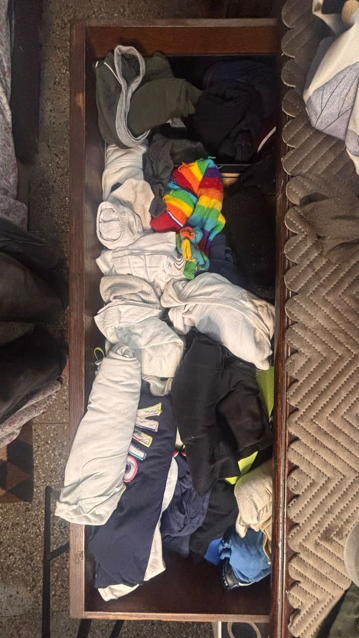 Before: a deep wooden drawer with t-shirts, hoodies and socks piled on top of each other