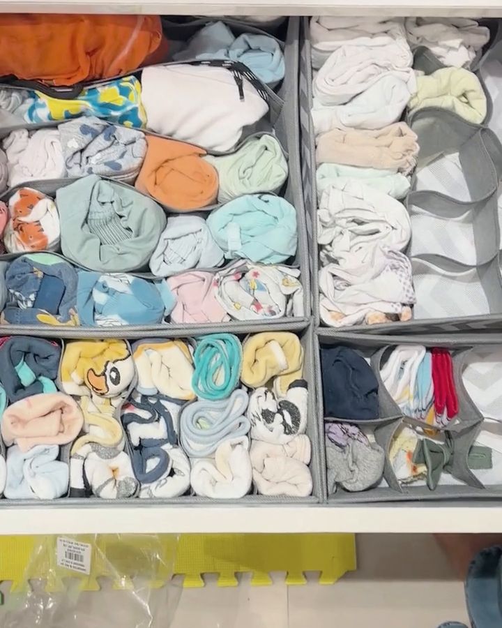 After: the same kids' drawer with clothes rolled into fabric dividers, with a few compartments left free