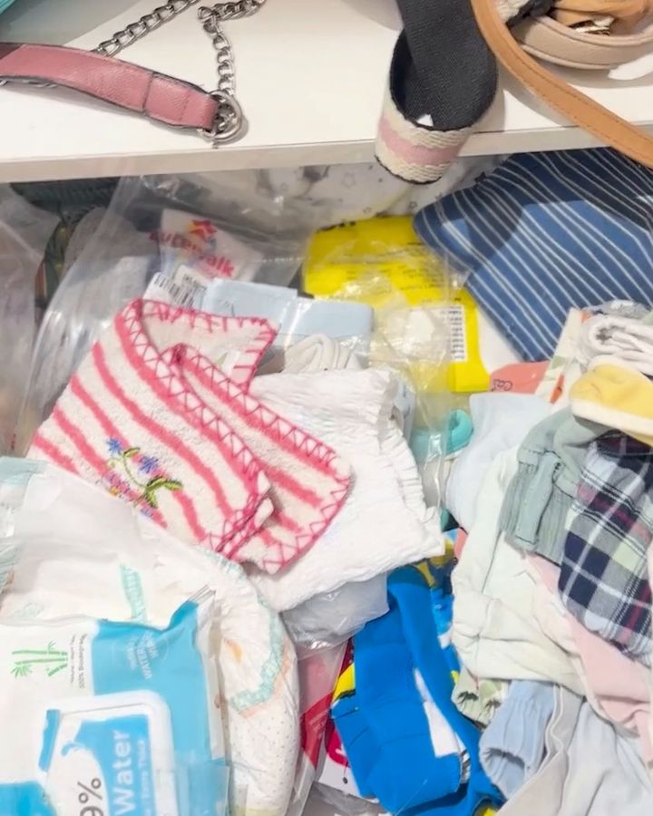 Before: a kids' clothes drawer overflowing with mixed clothes, wipes and plastic bags