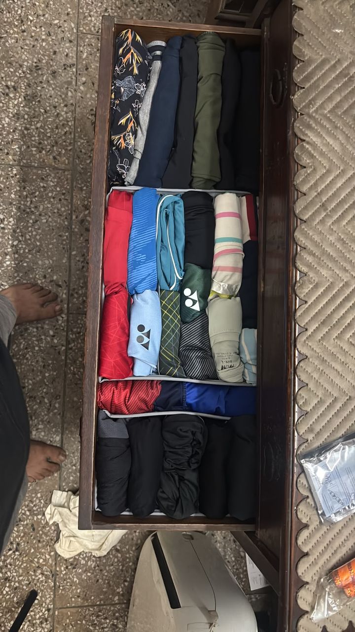 After: the same drawer with sportswear file-folded upright in rows by color
